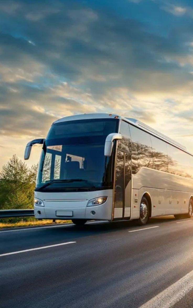 Coach bus on a highway at sunset